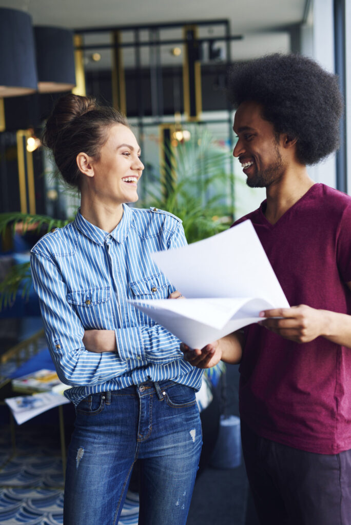 two people talking in a hip office space.