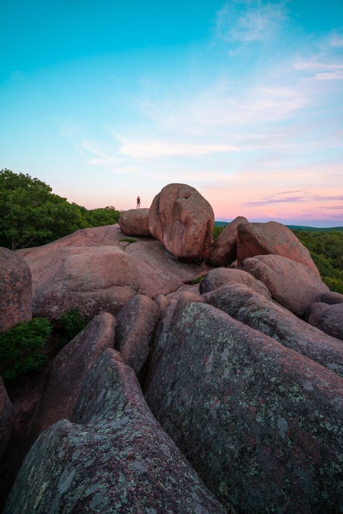 A person silhouetted by the sunset at Elephant Rocks State Park