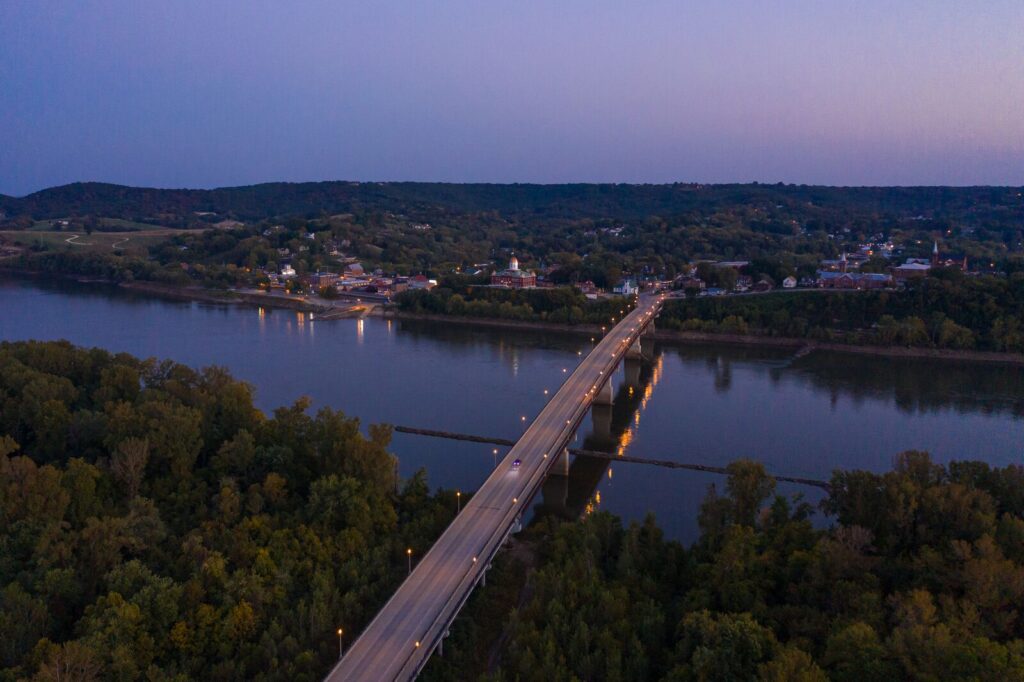 An overhead view of the town of Hermann. The bridge is illuminated over the Missouri River