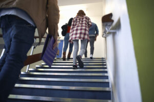 A group of people walking up the stairs.