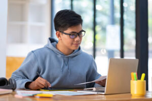 A student working on the computer building his portfolio.