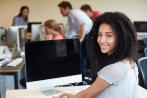 Student looking at camera away from computer
