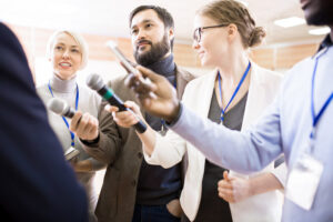 group of journalists interviewing someone, possibly a sports athlete.