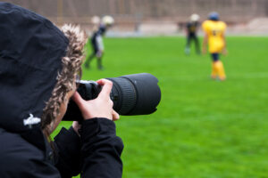 a sports photographer taking pictures of a game.