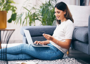 Student sitting on floor using laptop