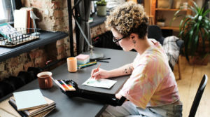 an artist with a prosthetic limb working with water colors.