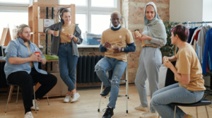 a group of coworkers sitting around and talking to each other